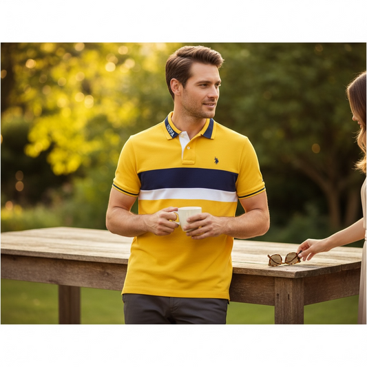 Hombre vistiendo polo amarillo con rayas azul marino y blanco de www.treshop.com.co en un jardín al atardecer.