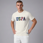 Hombre vistiendo camiseta de algodón color crema www.treshop.com.co con logo USPA estampado y cuello redondo