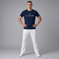 Hombre vistiendo camiseta azul marino de algodón U.S. POLO ASSN. con logo frontal y pantalones blancos en www.treshop.com.co