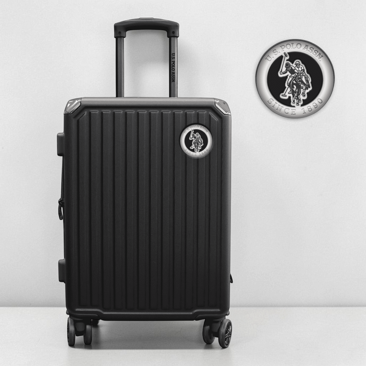 Maleta de viaje rígida negra U.S. POLO ASSN. con ruedas multidireccionales y asa telescópica de www.treshop.com.co