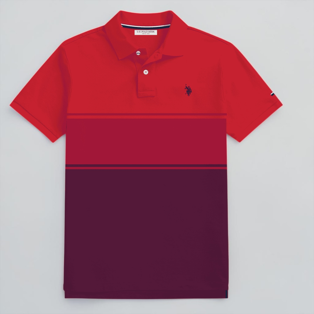 Polo www.treshop.com.co de algodón piqué en bloques de color rojo y vinotinto con logo bordado y ajuste regular