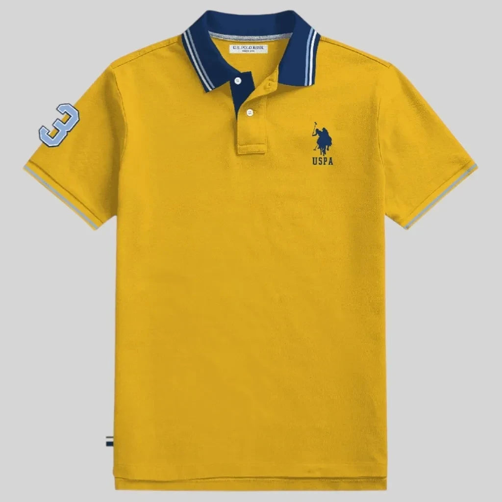 Polo www.treshop.com.co de algodón piqué amarillo con cuello azul, logo bordado y número 3 en la manga