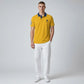Modelo vistiendo polo amarillo www.treshop.com.co de algodón piqué con cuello azul y logo bordado en el pecho